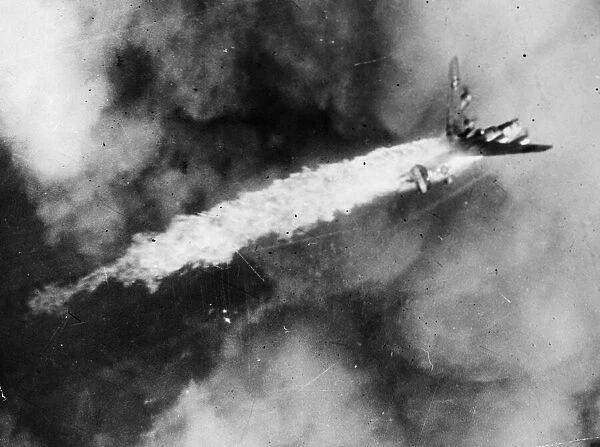 A B-24 Liberator bomber of the US Eighth Air Force Second Division goes down in flames