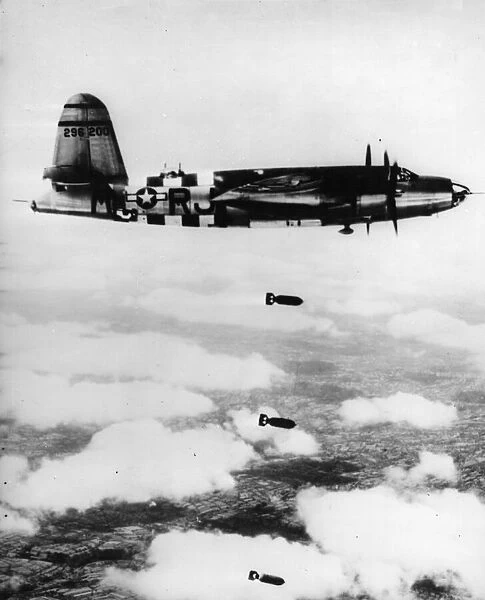 A B-26 Silver Streak Marauder of the ninth US Air Force, unloading its bombs over Torigni