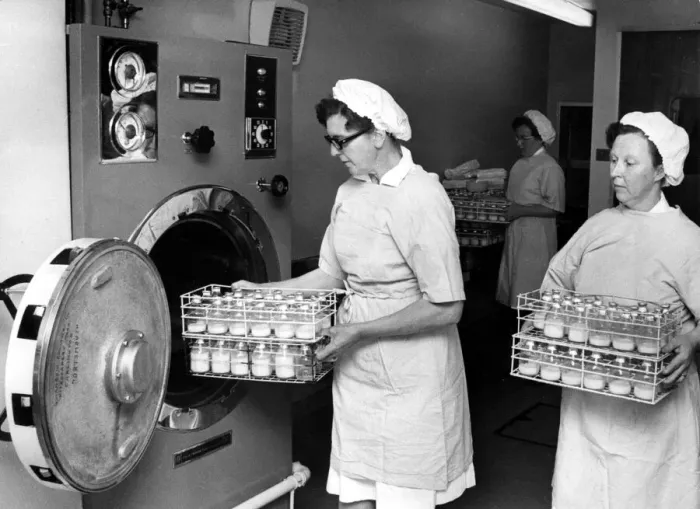 Framed Print : Babies milk bottles being taken out of the sterilising machine at the maternity unit Framed Print : Babies milk bottles being taken out of the sterilising machine at the maternity unit