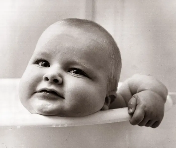 Framed Print : Baby in a bath tub, looking over the side. December 1963 Framed Print : Baby in a bath tub, looking over the side. December 1963