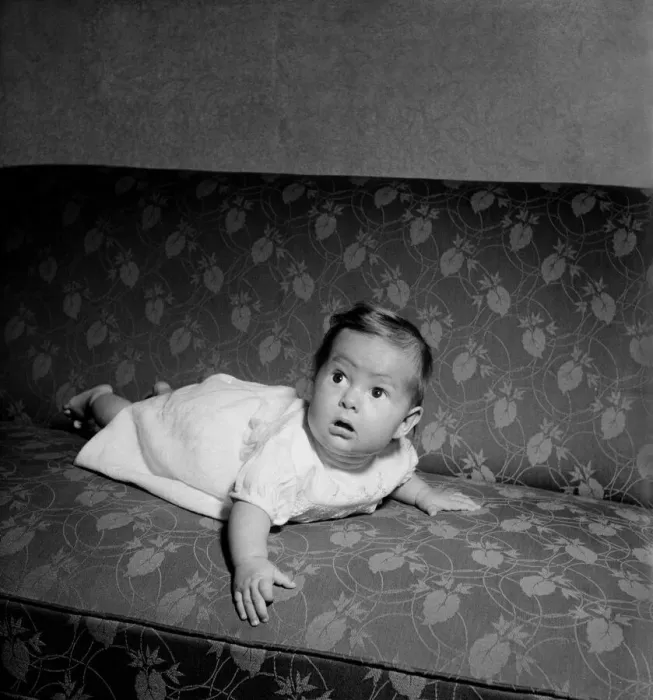 Framed Print : Baby crawling on the sofa at his home. August 1952 C3999