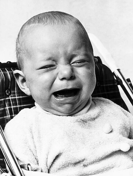 A baby crying as he sits in his high chair January 1973