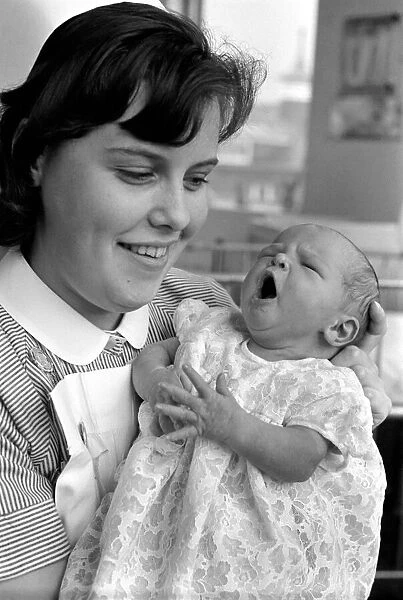 Baby girl in the arms of a nurse at a childrens hospital in Liverpool