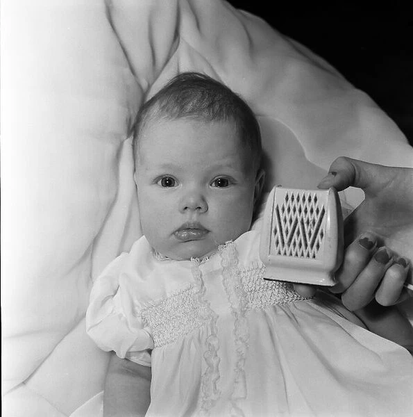 Baby Kim Wilde at home in Chiswick with a microphone. 30th January 1961