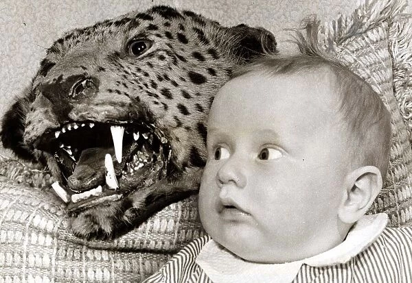 a Baby looks in shock at the scary leopard behind her - it doesn t matter that it