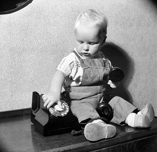 Baby and telephone. August 1952 C4052