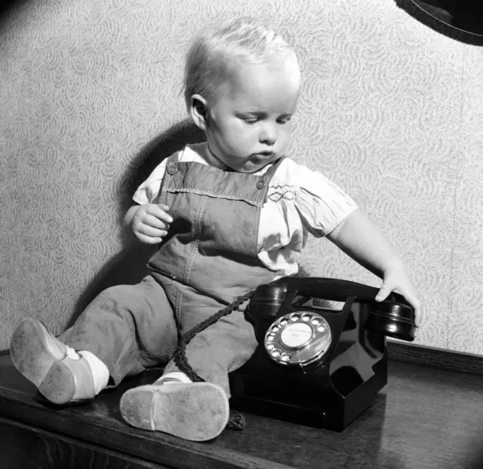 Framed Print : Baby and telephone. August 1952 C4052 Framed Print : Baby and telephone. August 1952 C4052