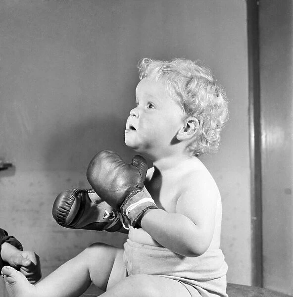 Baby wearing boxing gloves. October 1952 C5091