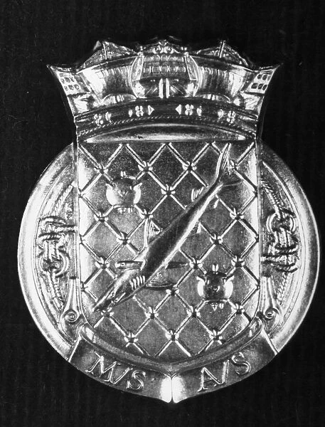 The badge worn by personnel of the HM Minesweepers. April 1945