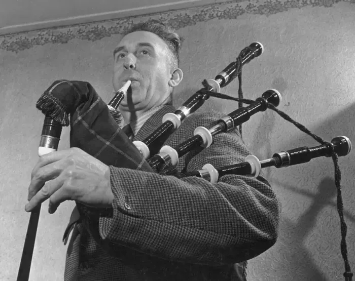 Framed Print : Bagpip tutir and expert Mr McCauley testing one of the new bagpipes made a London firm