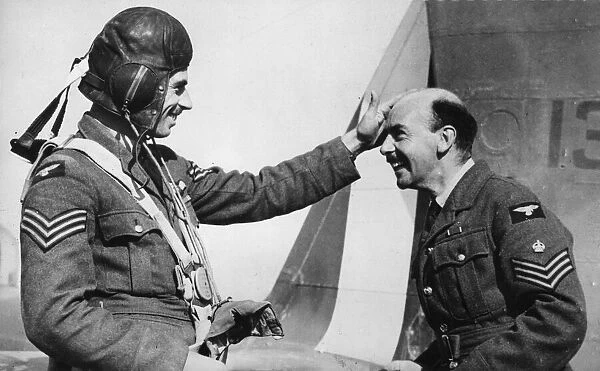 The bald pate of the smiling Flight-Sergeant seen on the right of the picture is the