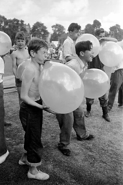 Balloon bursting competition during a childrens sports day. August 1952 C4047