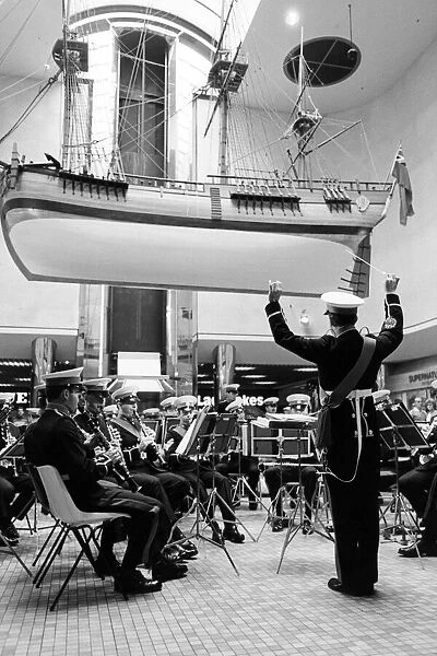 A band plays beneath a replica of Captain Cooks ship 'Endeavour'