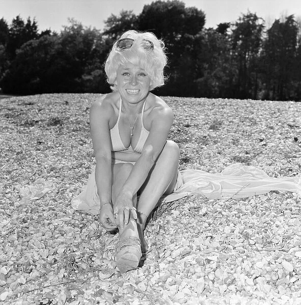 Barbara Windsor, Actress, 7th July 1976. Pictured, taking a break from an unusual role
