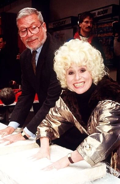Barbara Windsor and Oliver Reed aftr leaving their palm prints in cement Plaque