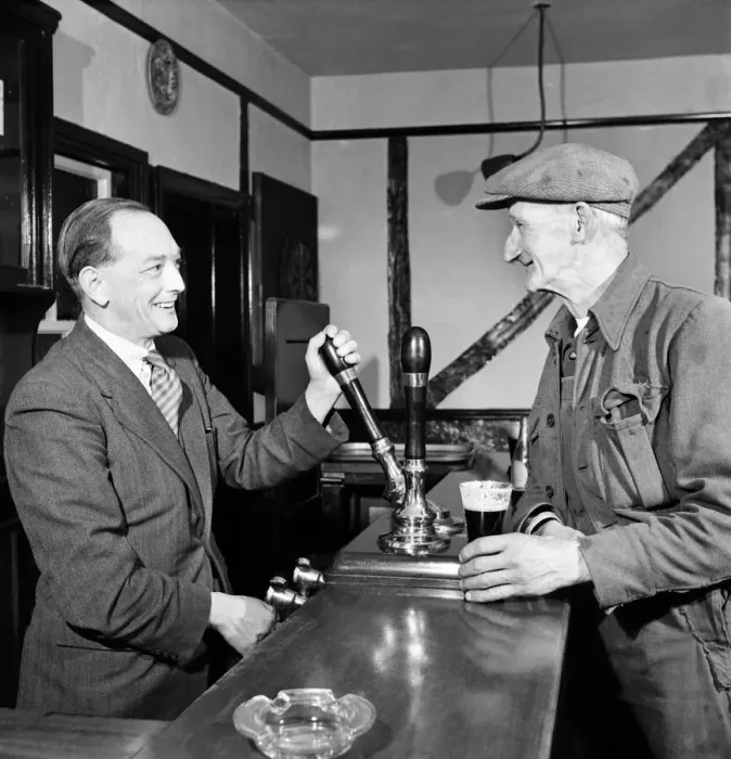 Framed Print : Barman pours a pint for a regular customer at a public house October 1952 C5351A Framed Print : Barman pours a pint for a regular customer at a public house October 1952 C5351A