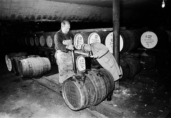 Barrels being tested in the bonded warehouse at the Knockando Whisky Distillery, Moray