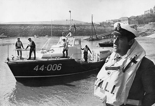 The Barry coxswain, Mr. Frank Tinsley, ready to board one of the Royal National Lifeboat