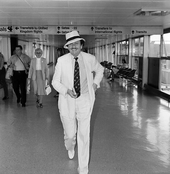 Barry Humphries leaving Heathrow Airport for New York. 10th August 1983