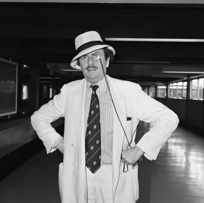 Framed Print : Barry Humphries leaving Heathrow Airport for New York. 10th August 1983