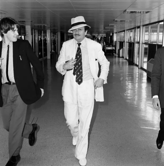 Framed Print : Barry Humphries leaving Heathrow Airport for New York. 10th August 1983 Framed Print : Barry Humphries leaving Heathrow Airport for New York. 10th August 1983