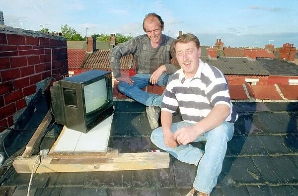 Barry Kirkham and his mate Kevin sitting on a roof top tuning in to the England v West