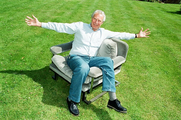 Barry Norman Film Critic seen here in the garden of his Datchworth home with the chair he
