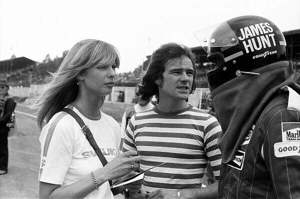 Barry Sheene and his girlfriend Stephanie McLean talking to James Hunt at a practice day