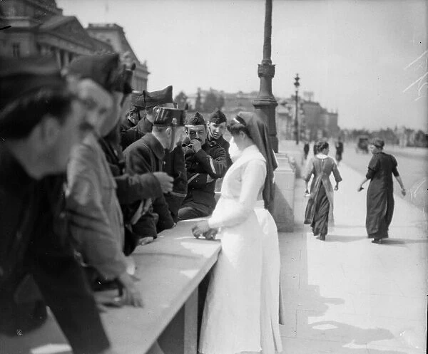 A batch of English nurses seen here talking to Belgian soldiers outside the Royal Palace