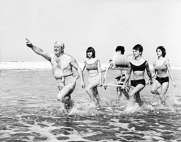 Bathers attempting a swimming rescue on the beach Unknown date