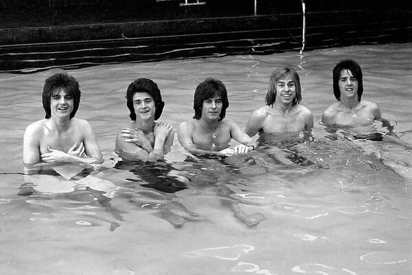 The Bay City Rollers celebrate their chart success with a quick dip in the pool
