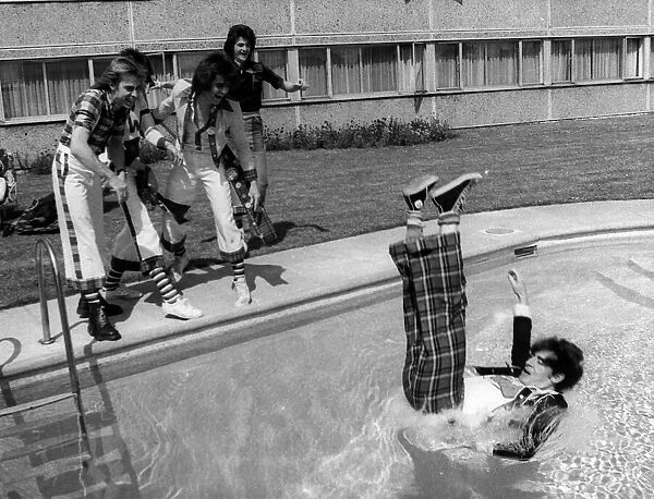Bay City Rollers guitarist Alan Longmuir is thrown into the swimming pool by other band