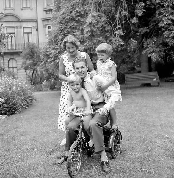 BBC Announcer Alexander McIntosh seen here at home with his wife and children. Circa 1957
