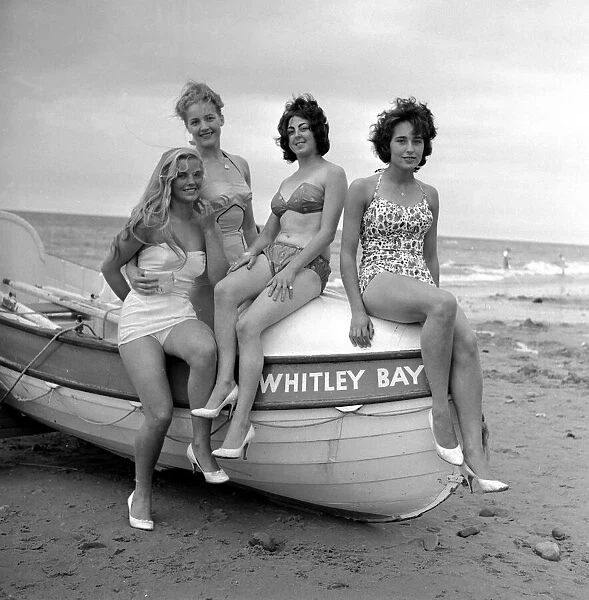 Beach beauty girls sitting on a boat in Whitley Bay. 28th July 1960