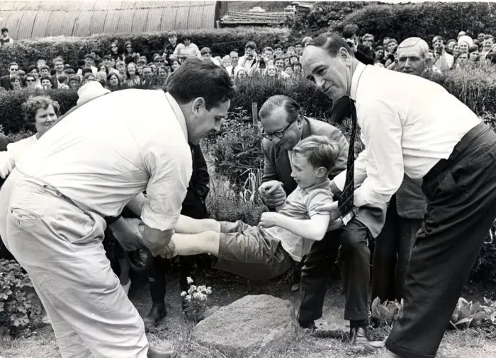 Framed Print : Beating the bounds - Llantrisant - Townspeople watch as seven-year-old Kevin Davies is Framed Print : Beating the bounds - Llantrisant - Townspeople watch as seven-year-old Kevin Davies is