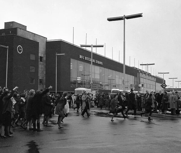 The Beatles arrive at London airport from Sweden. Fans running across the airport to