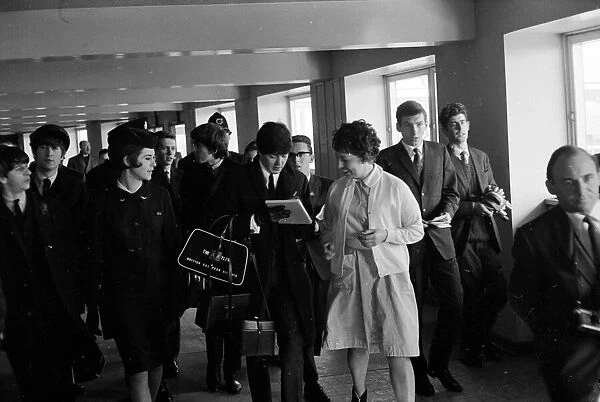 The Beatles arrive back in London from Paris February 1964 Paul McCartney signs