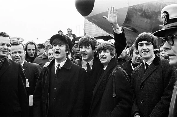 The Beatles arrive in New York for a 10-day tour on Pan Am Flight 101 at Kennedy Airport