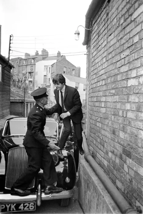 Framed Print : The Beatles August 1964 Paul McCartney is helped over his car by a guard to escape Framed Print : The Beatles August 1964 Paul McCartney is helped over his car by a guard to escape