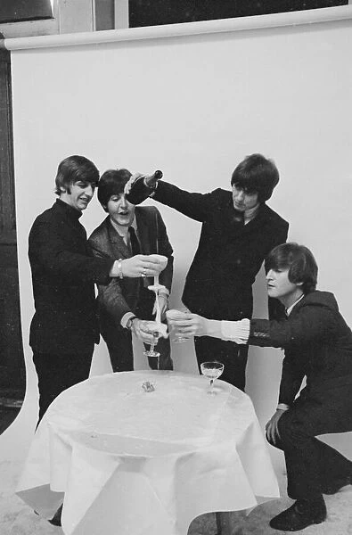 Beatles celebrating chart success. January 1965