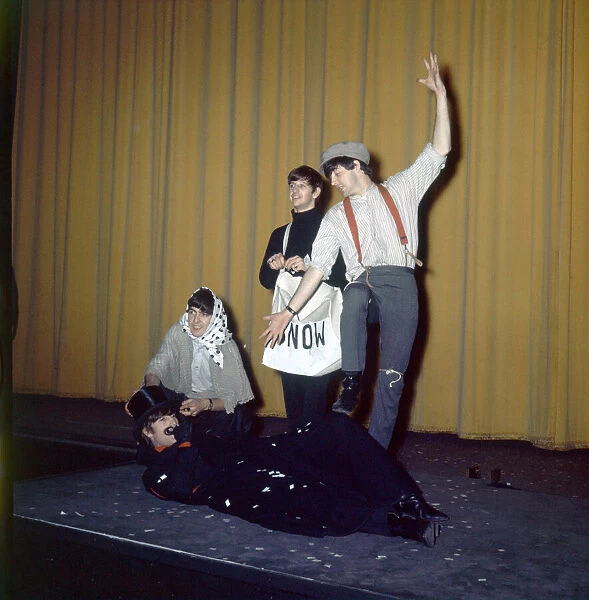 The Beatles in costume seen here rehearsing on stage for their Christmas Show at