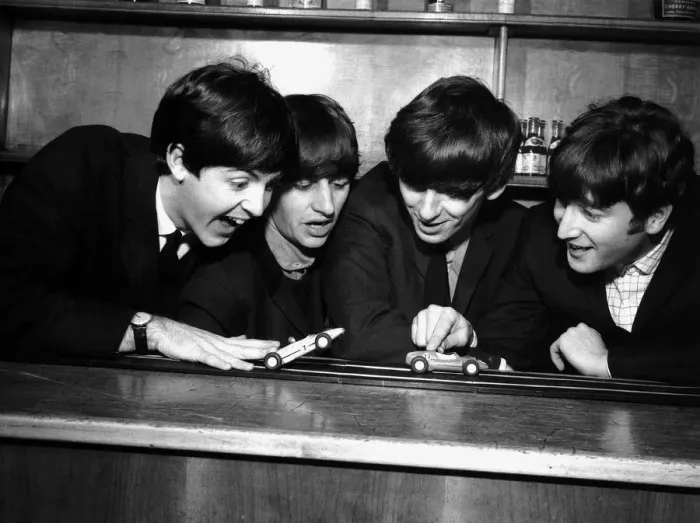 Framed Print : The Beatles in Coventry, amusing themselves with a miniature car race track before their Framed Print : The Beatles in Coventry, amusing themselves with a miniature car race track before their