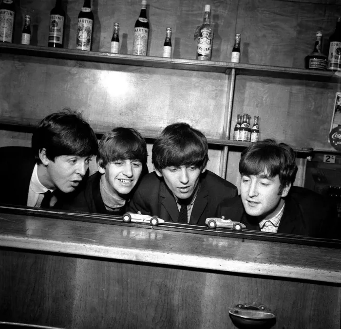 Framed Print : The Beatles in Coventry, amusing themselves with a miniture car race track before