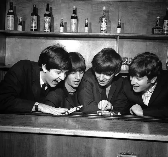 Framed Print : The Beatles in Coventry, amusing themselves with a miniture car race track before