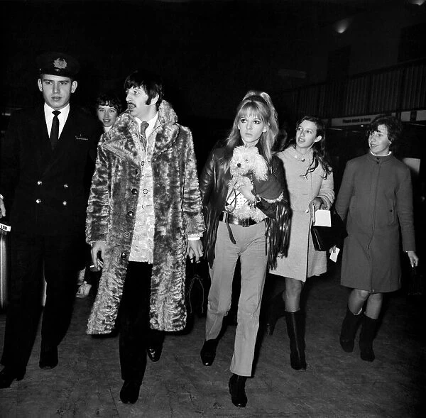 Beatles drummer Ringo Starr and his wife Maureen with their pet poodle at Heathrow
