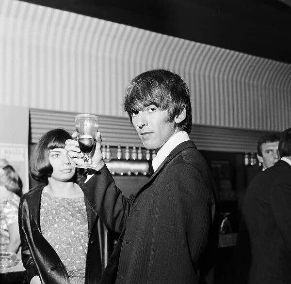 The Beatles George Harrison in the saloon bar of the Prince of Wales Theatre in London