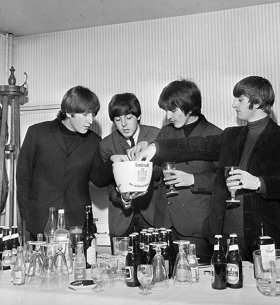 The Beatles helping themselves to drinks in hospitality area at a press reception at