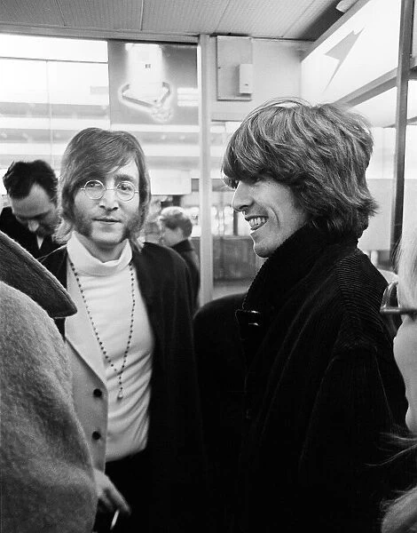 Beatles John Lennon and George Harrison at Heathrow Airport before departing to India