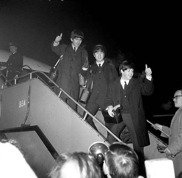 Beatles left to right: George Harrison, John Lennon and Paul McCartney boarding the plane