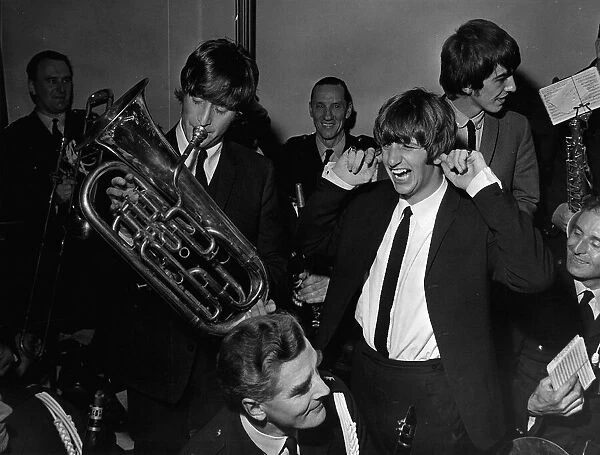Beatles in Liverpoool, drummer Ringo Starr puts his fingers in his ears to block